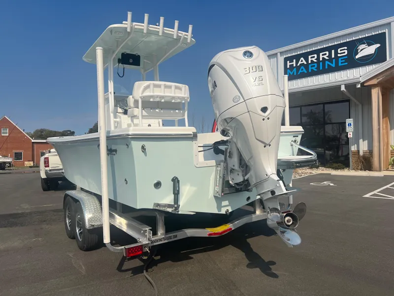 Slide: The Image of 2025 Pair Customs 24 Bay boat on trailer at Harris Marine dealership. - 3