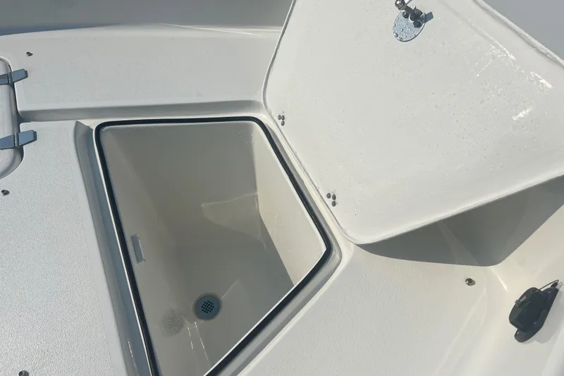 Slide: The Image of Open storage compartment on 2025 Pair Customs 24 Bay boat. - 30