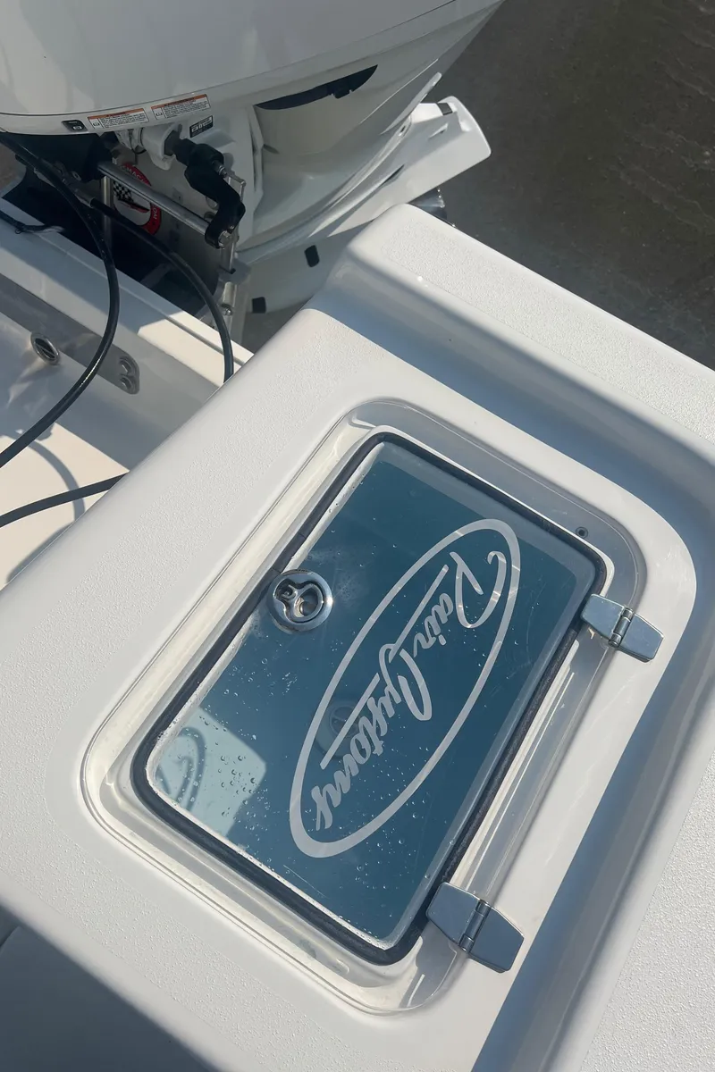 Slide: The Image of 2025 Pair Customs 24 Bay boat detail with logo on deck compartment. - 38