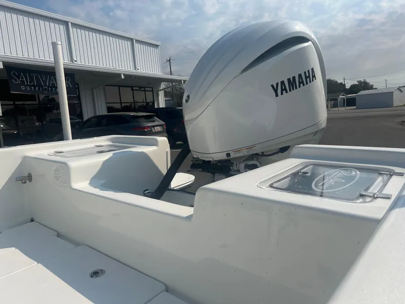 Slide: The Image of 2025 Pair Customs 24 Bay boat with Yamaha outboard motor, parked near Salty Harbor. - 5