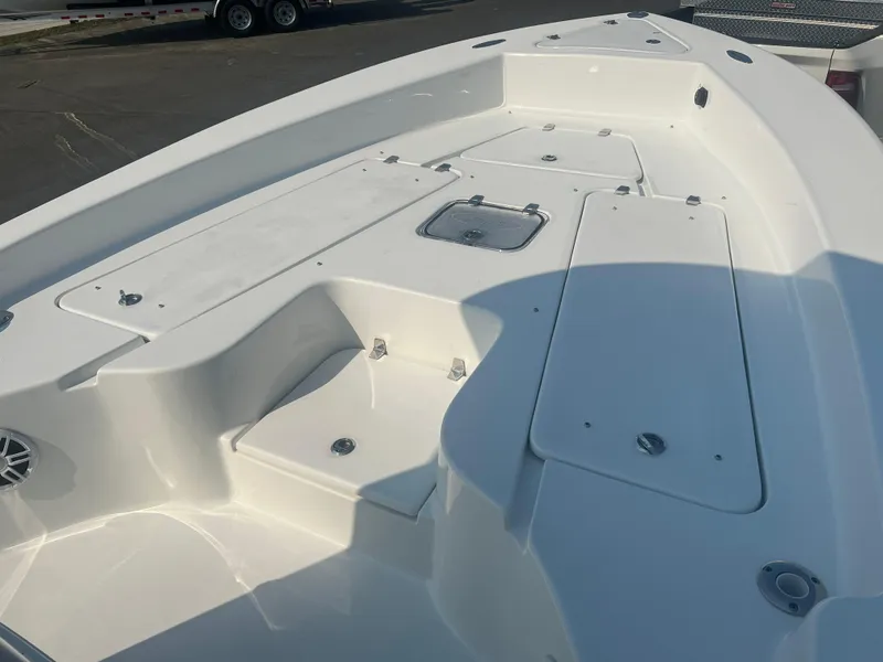 Slide: The Image of 2025 Pair Customs 24 Bay boat deck with storage compartments and sleek design. - 8