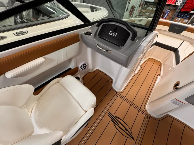 Slide: The Image of 2025 Chaparral 21 SSi OB boat interior with modern dashboard and seating. - 21