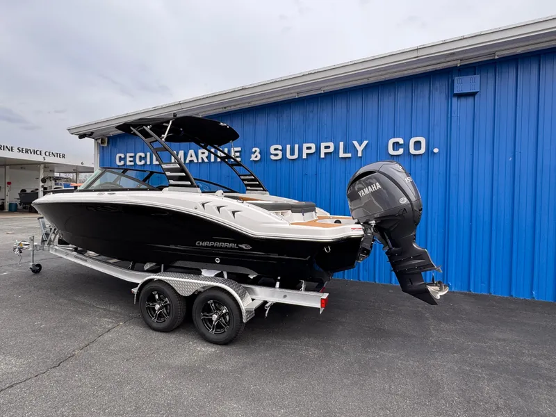 Slide: The Image of 2025 Chaparral 21 SSi OB boat on trailer at marine supply store. - 4