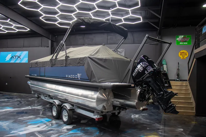 Slide: The Image of 2025 Viaggio Lago X-Q pontoon boat in showroom with modern lighting. - 26