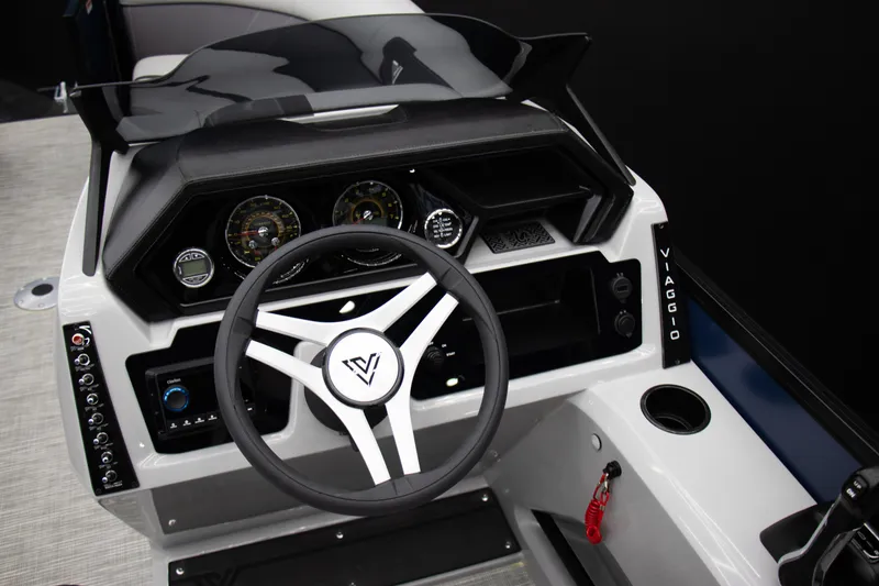 Slide: The Image of 2025 Viaggio Lago X-Q boat dashboard with steering wheel and control panel. - 4