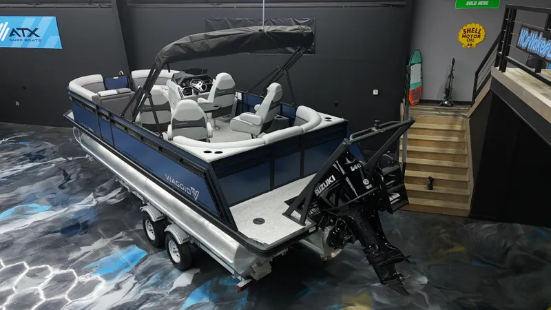 Slide: The Image of 2025 Viaggio Lago X-Q pontoon boat in showroom, featuring sleek design and modern seating. - 5