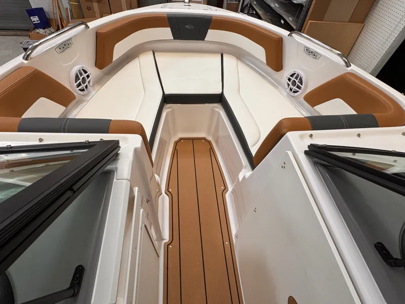 Slide: The Image of 2025 Chaparral 21 SSi OB boat interior with tan and white seating. - 12