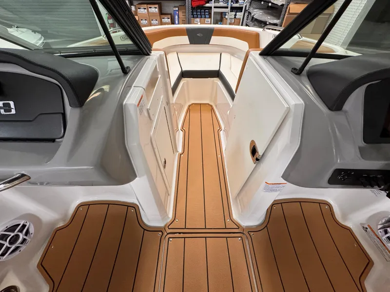 Slide: The Image of 2025 Chaparral 21 SSi OB boat interior with tan flooring and seating. - 20