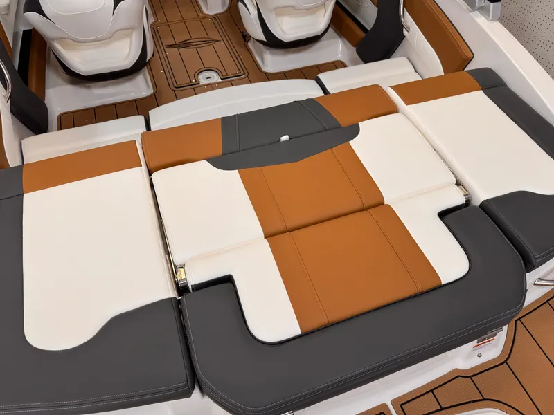Slide: The Image of 2025 Chaparral 21 SSi OB boat interior with stylish, cushioned seating in brown, white, and gray. - 6