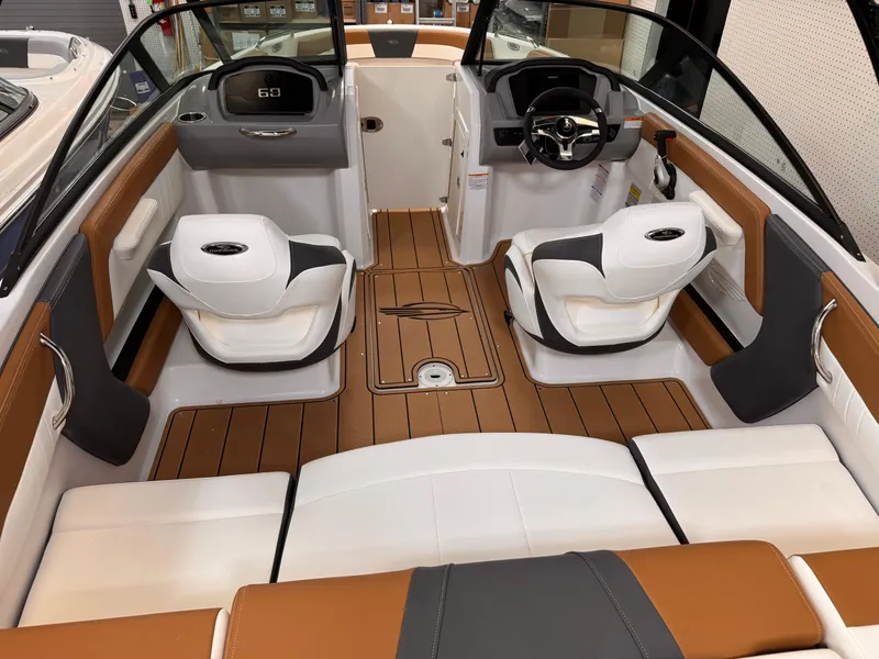 Slide: The Image of 2025 Chaparral 21 SSi OB boat interior with modern seating and sleek dashboard design. - 8
