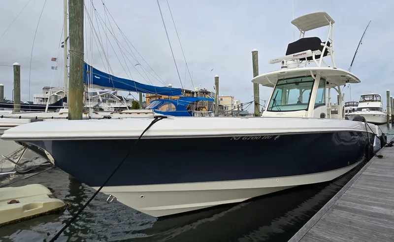 The Image of 2015 Boston Whaler 350 Outrage boat docked at marina, side view. - 0