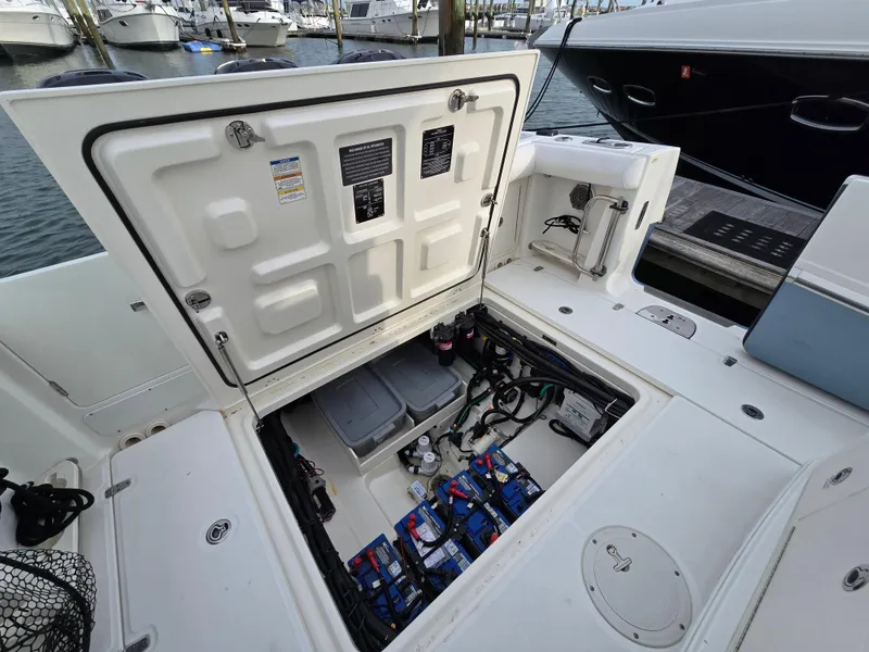 Slide: The Image of 2015 Boston Whaler 350 Outrage boat with open hatch showing engine compartment. - 18