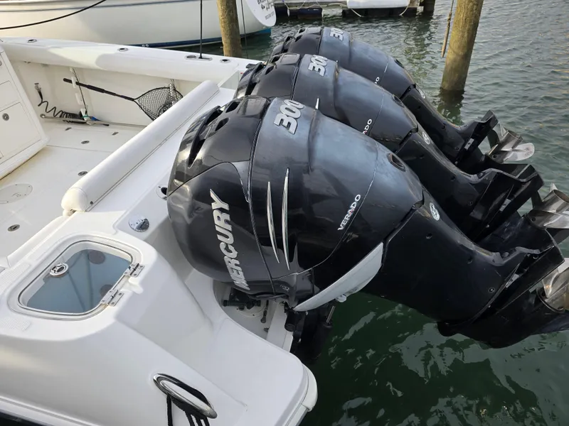 Slide: The Image of 2015 Boston Whaler 350 Outrage with triple Mercury 300 engines docked in marina. - 29
