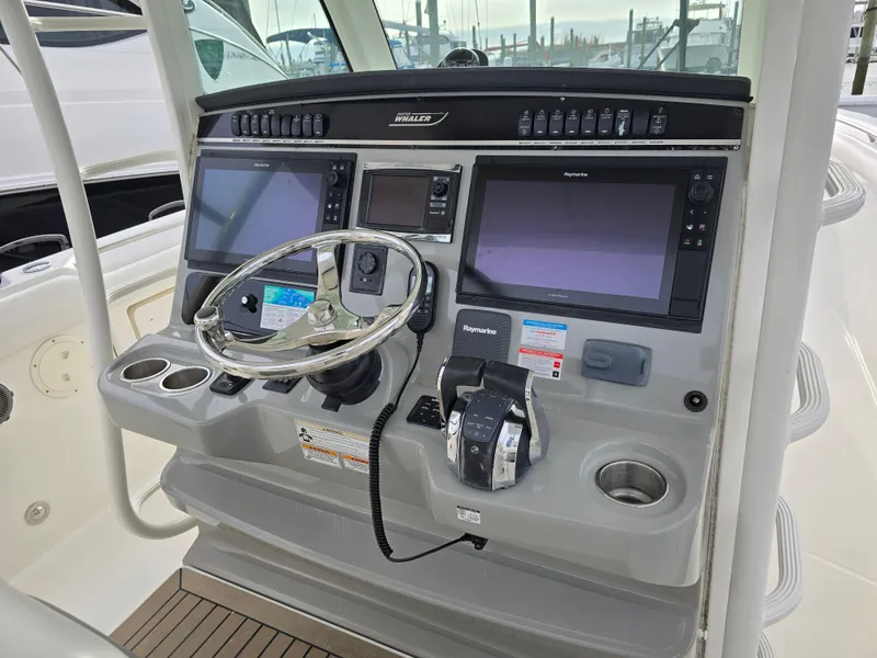 Slide: The Image of Control panel of 2015 Boston Whaler 350 Outrage with dual screens and steering wheel. - 8