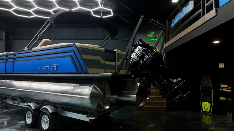 Slide: The Image of 2025 Viaggio Lago Z-U pontoon boat displayed indoors on a trailer. - 19