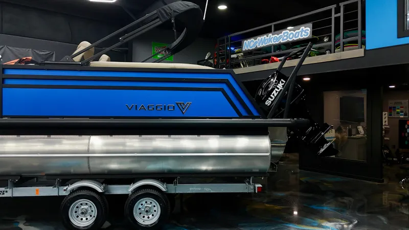 Slide: The Image of 2025 Viaggio Lago Z-U pontoon boat on trailer in showroom. - 20