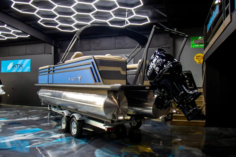 Slide: The Image of 2025 Viaggio Lago Z-U pontoon boat on trailer in modern showroom. - 3