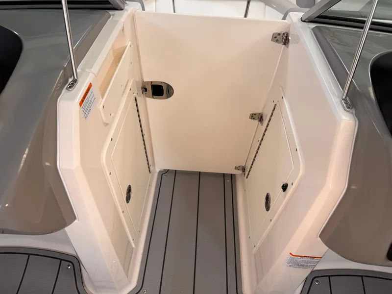Slide: The Image of 2025 Chaparral 21 SSi OB boat interior with storage compartments and sleek design. - 11