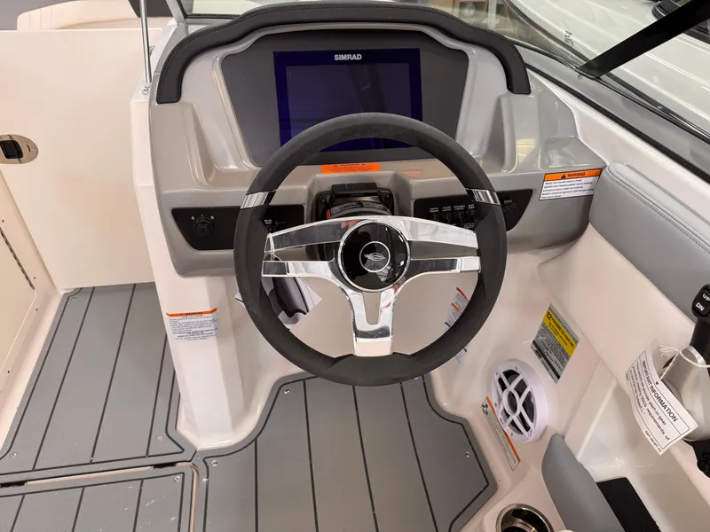 Slide: The Image of 2025 Chaparral 21 SSi OB boat dashboard with steering wheel and digital display. - 16