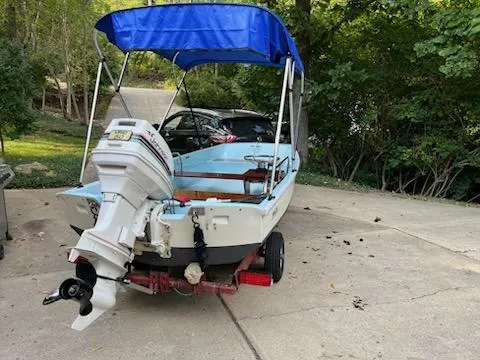 Slide: The Image of 1964 Boston Whaler 13 Sport boat with blue canopy on a trailer. - 3