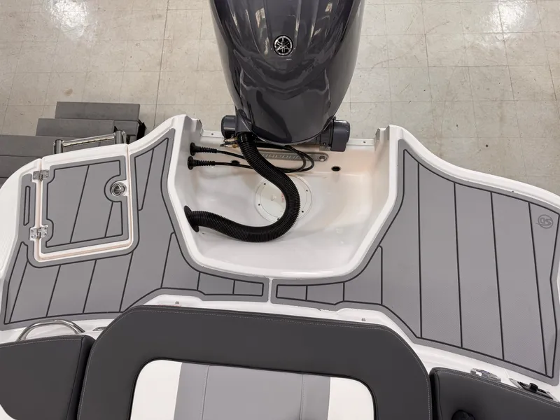 Slide: The Image of 2025 Chaparral 21 SSi OB boat deck with outboard motor, featuring sleek design and modern fittings. - 21