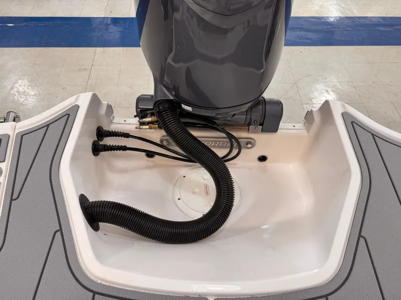Slide: The Image of 2025 Chaparral 21 SSi OB boat engine compartment with visible wiring and hoses. - 37
