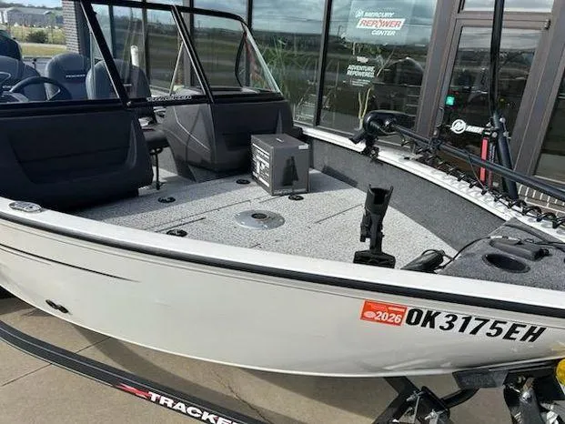 Slide: The Image of 2021 Tracker Pro Guide V-16 WT boat on trailer, displayed outdoors. - 10