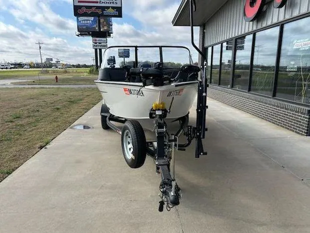 Slide: The Image of 2021 Tracker Pro Guide V-16 WT boat on trailer outside a building. - 5