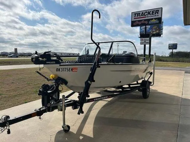 Slide: The Image of 2021 Tracker Pro Guide V-16 WT boat on trailer, parked outdoors under cloudy sky. - 7