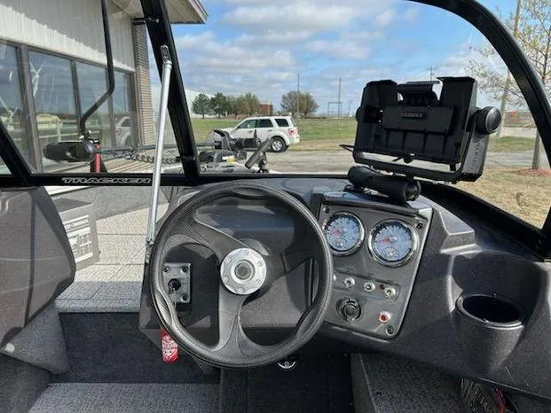 Slide: The Image of 2021 Tracker Pro Guide V-16 WT boat dashboard with steering wheel and gauges. - 9