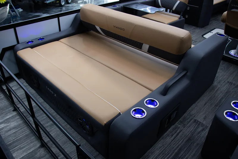 Slide: The Image of 2025 Viaggio Lago Z-S boat interior with tan seating and illuminated cup holders. - 26