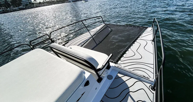 Slide: The Image of 2025 Pontoon Harpoon boat on water, featuring sleek design and comfortable seating. - 14