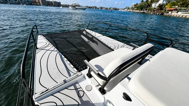 Slide: The Image of 2025 Pontoon Harpoon boat on water, featuring sleek design and comfortable seating. - 16