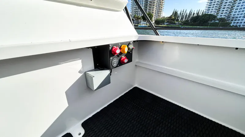 Slide: The Image of 2025 Pontoon Harpoon boat interior with control panel, overlooking waterfront and cityscape. - 22