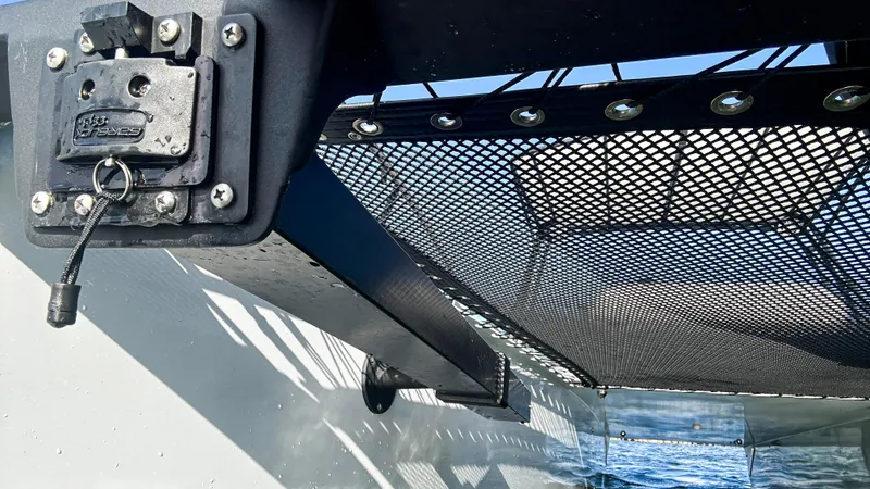Slide: The Image of 2025 Pontoon Harpoon boat with mesh netting and secure latch system. - 24