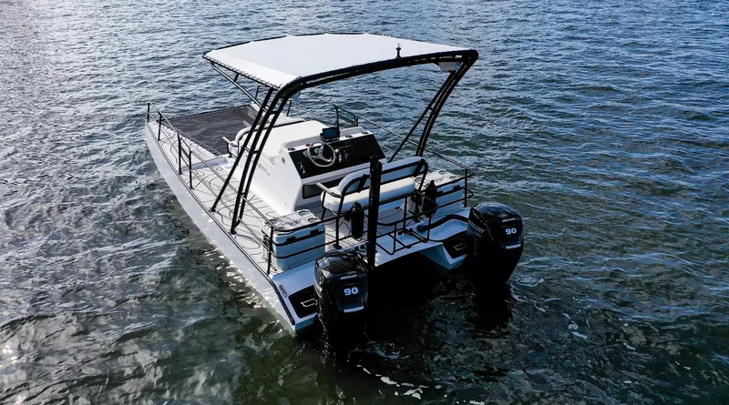 Slide: The Image of 2025 Pontoon Harpoon boat with dual engines on open water. - 7