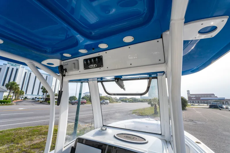 Slide: The Image of 2018 Sea Hunt 255 SE boat interior with blue canopy and control panel. - 19