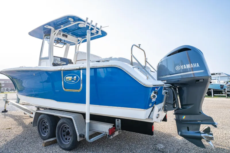 Slide: The Image of 2018 Sea Hunt 255 SE boat with Yamaha engine on trailer, blue and white design. - 5