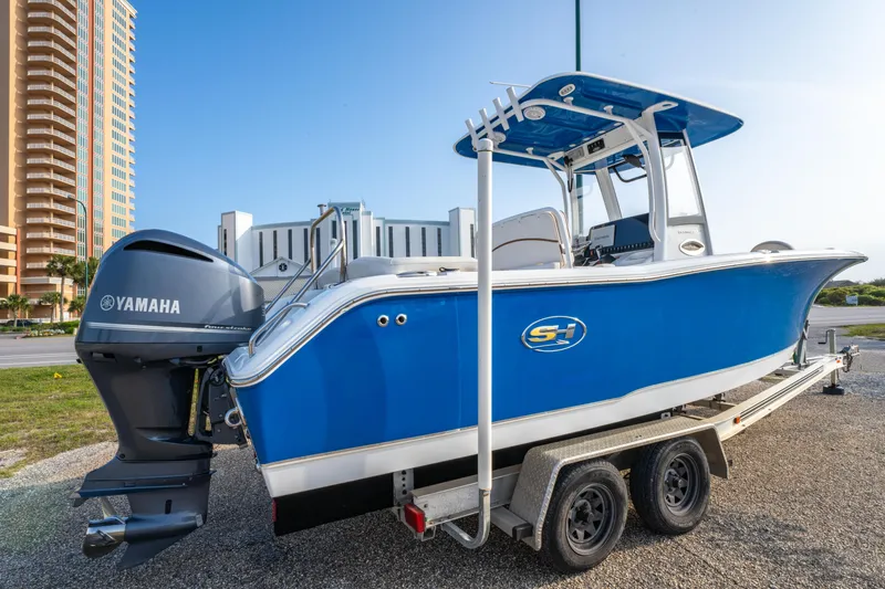 Slide: The Image of 2018 Sea Hunt 255 SE boat with Yamaha engine on a trailer, parked outdoors. - 6