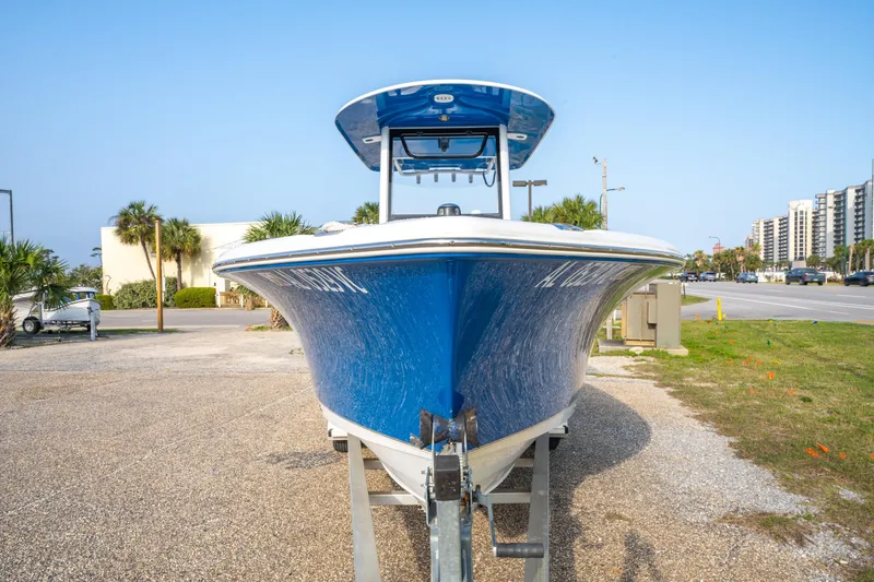Slide: The Image of 2018 Sea Hunt 255 SE boat on trailer, blue hull, parked outdoors. - 9