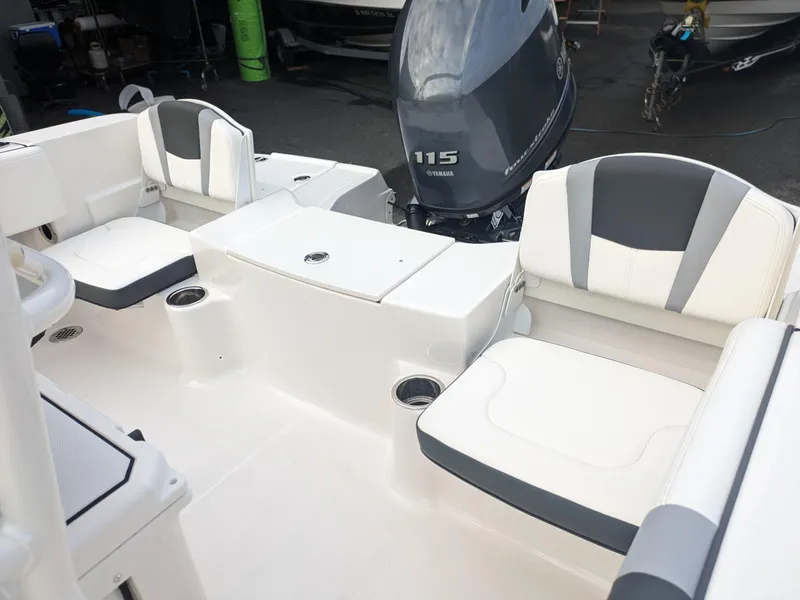 Slide: The Image of 2025 Robalo R180 Center Console boat interior with seating and Yamaha 115 engine. - 16