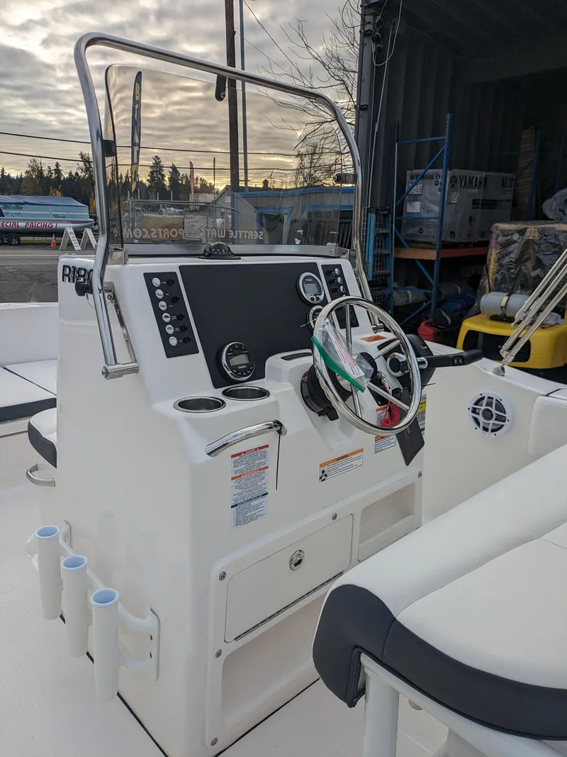 Slide: The Image of 2025 Robalo R180 Center Console boat with modern dashboard and steering wheel. - 17