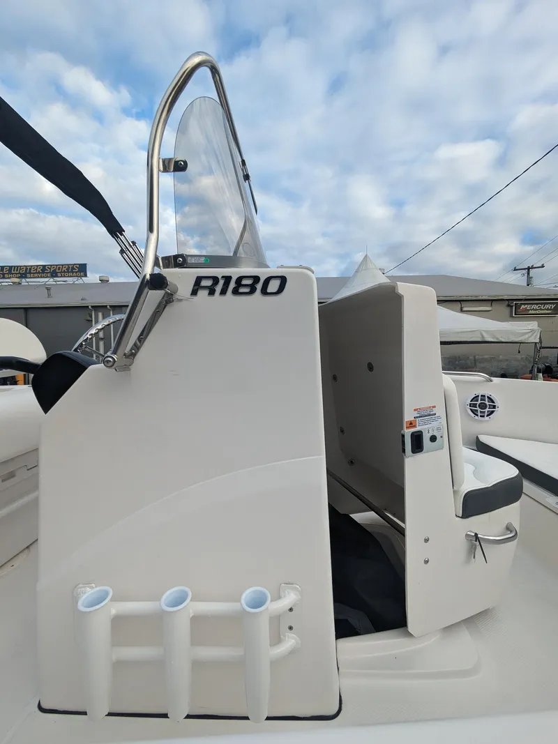Slide: The Image of 2025 Robalo R180 Center Console boat with sleek design and rod holders. - 19