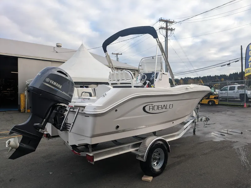 Slide: The Image of 2025 Robalo R180 Center Console boat with Yamaha engine on trailer. - 2