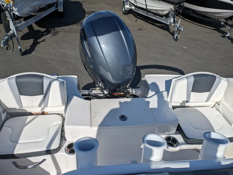 Slide: The Image of 2025 Robalo R180 Center Console boat with seating and motor, parked on a trailer. - 24