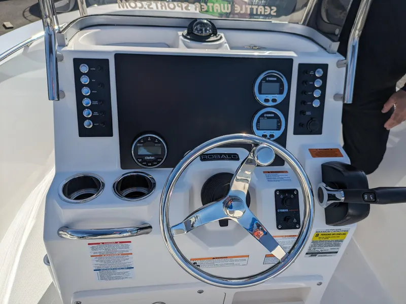 Slide: The Image of 2025 Robalo R180 Center Console dashboard with steering wheel and control panel. - 8