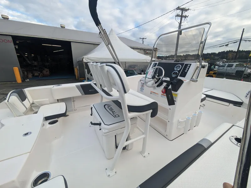 Slide: The Image of 2025 Robalo R180 Center Console boat interior with helm and seating. - 9