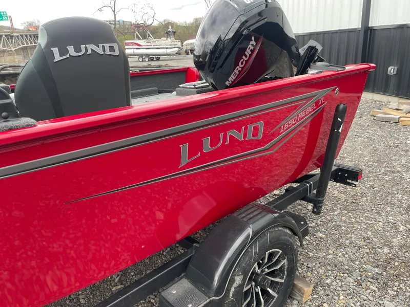 Slide: The Image of 2025 Lund 1650 Rebel XL Sport boat in vibrant red with Mercury engine. - 10