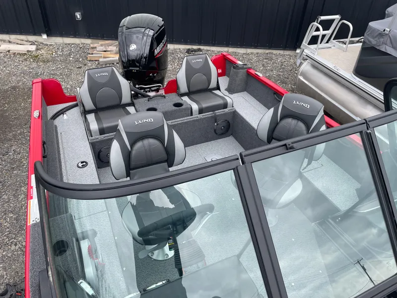 Slide: The Image of 2025 Lund 1650 Rebel XL Sport boat interior with seating and motor, viewed from above. - 11