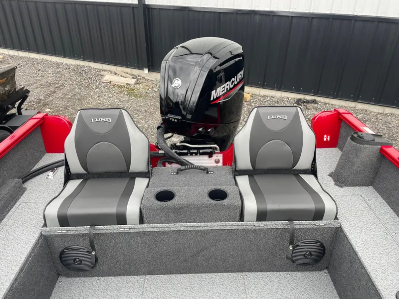 Slide: The Image of 2025 Lund 1650 Rebel XL Sport boat interior with dual seats and Mercury engine. - 14
